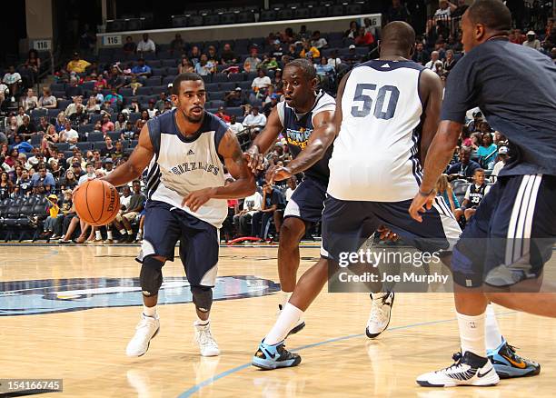 Mike Conley of the Memphis Grizzlies drives past Ronald Murray of the Memphis Grizzlies during an Open Practice on October 13, 2012 at FedExForum in...