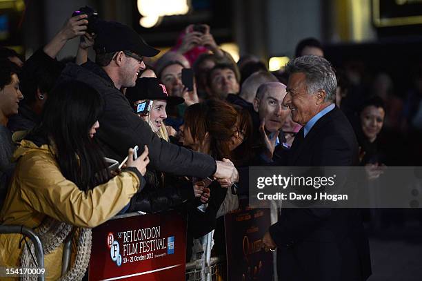 Director Dustin Hoffman shakes hands with a member of the crowd at the premiere of 'Quartet' during the 56th BFI London Film Festival at Odeon...