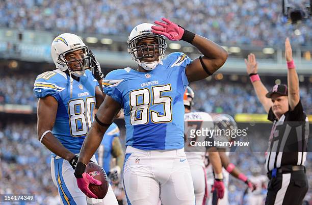 Antonio Gates of the San Diego Chargers celebrates his first quarter touchdown against the Denver Broncos as teammate Malcom Floyd looks on during...