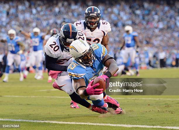 Antonio Gates of the San Diego Chargers dives into the end zone for a touchdown in the first quarter past Mike Adams of the Denver Broncos during the...