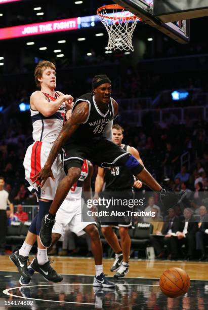 Gerald Wallace of the Brooklyn Nets battles for a rebound against Jan Vesely of the Washington Wizards during a preseason game at the Barclays Center...