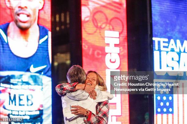 Marathon runner Deena Kastor gives a hug to Olympic Marathon medalist Joan Benoit Samuelson during the U.S. Olympic Trials Marathon Opening Ceremony...