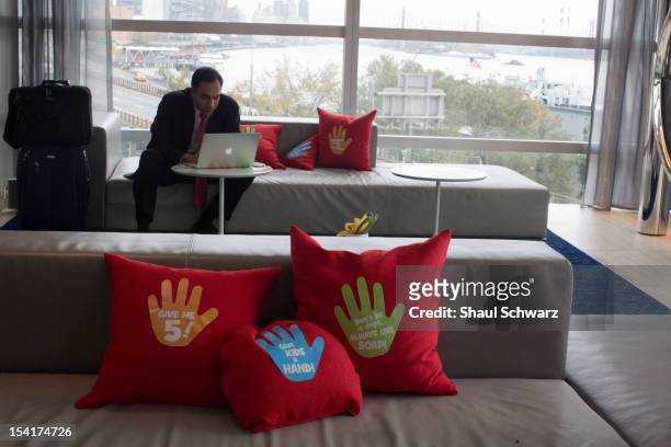 Pillows with handwashing icons are seen on a couch while Professor Jeffrey Sachs Director of the Earth Institute, and Paul Polman CEO Unilever, speak...