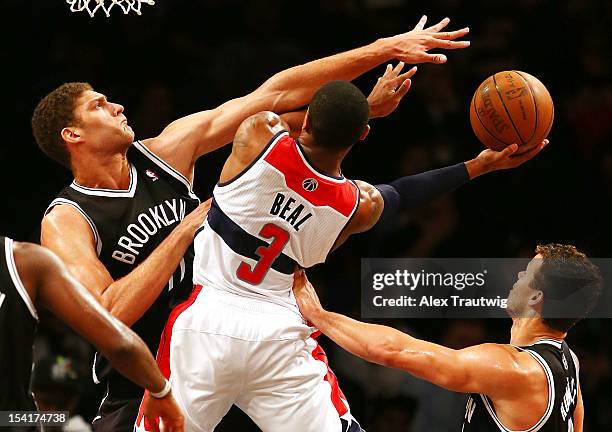 Bradley Beal of the Washington Wizards drives to the basket as Brook Lopez of the Brooklyn Nets defends during a preseason game at the Barclays...