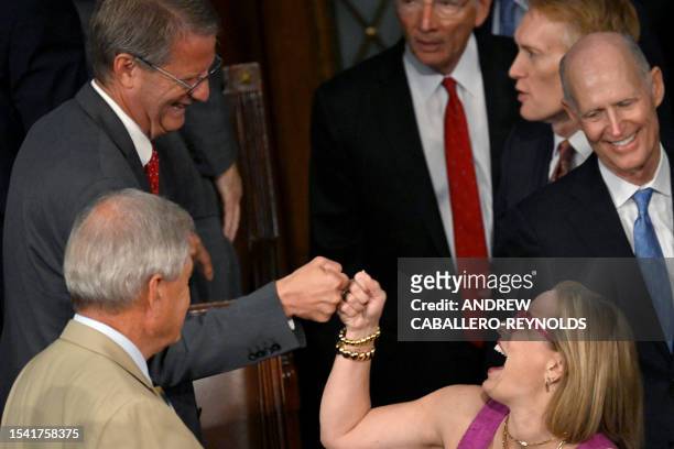 Representative Tim Burchett fist bumps US Senator Kyrsten Sinema as she arrives prior to an address by Israeli President Isaac Herzog, during a Joint...