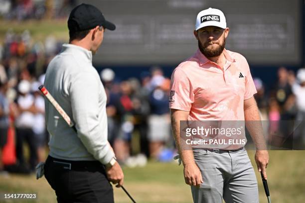 Northern Ireland's Rory McIlroy talks with England's Tyrrell Hatton on the 14th green during a practice round for 151st British Open Golf...