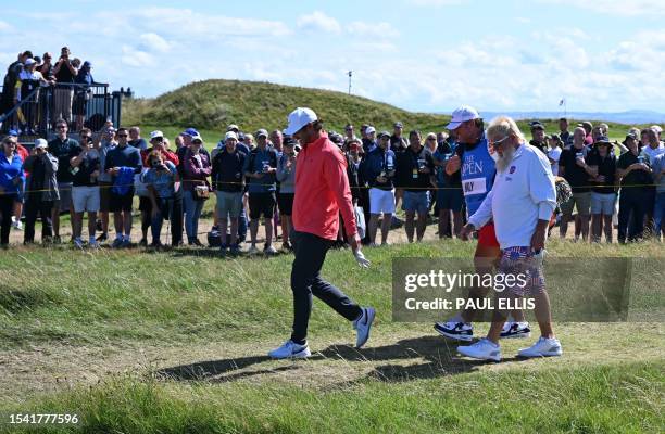 Golfer John Daly leaves the 15th tee during a practice round for 151st British Open Golf Championship at Royal Liverpool Golf Course in Hoylake,...