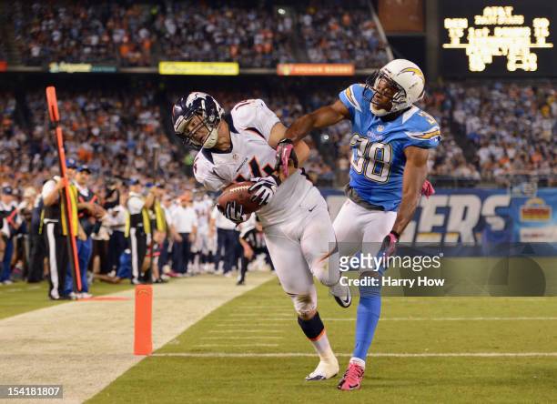 Brandon Stokley of the Denver Broncos maks the catch for a touchdown in the fourth quarter against Marcus Gilchrist of the San Diego Chargers during...