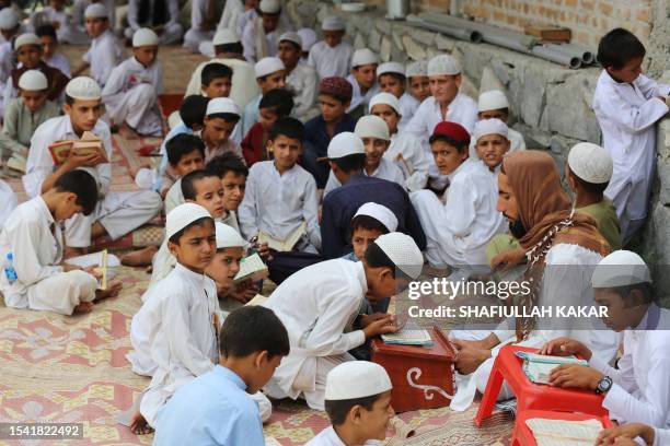 Afghan boys learn the holy Koran at a madrassa or an Islamic school in Kama District of Nangarhar province on July 19, 2023