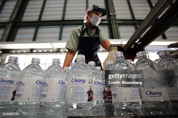 Bottles of Thai Beverage Pcl drinking water move along the production line at the company's Beer Thip brewery in Bang Ban, Ayutthaya province,...