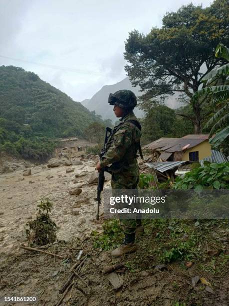 Rescue teams with drones search for survivors after a landslide triggered by heavy rains left at least 10 people dead and about a dozen missing in...