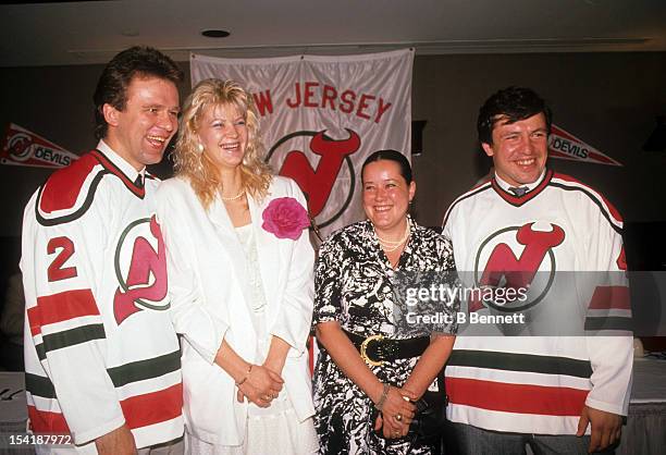 Viacheslav Fetisov and Sergei Starikov of the Soviet Union sign with the New Jersey Devils during a press conference on July 7, 1989 at the Brendan...