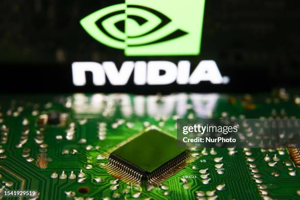 Nvidia logo displayed on a phone screen and microchip and are seen in this illustration photo taken in Krakow, Poland on July 19, 2023.