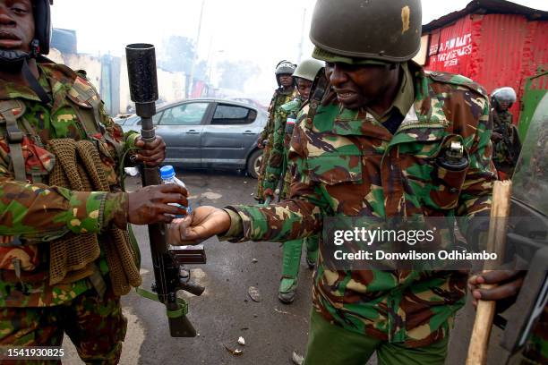 Riot police use water to wash off teargas from their faces during the Azimio la Umoja-One Kenya third wave protest over high living cost on July 19,...