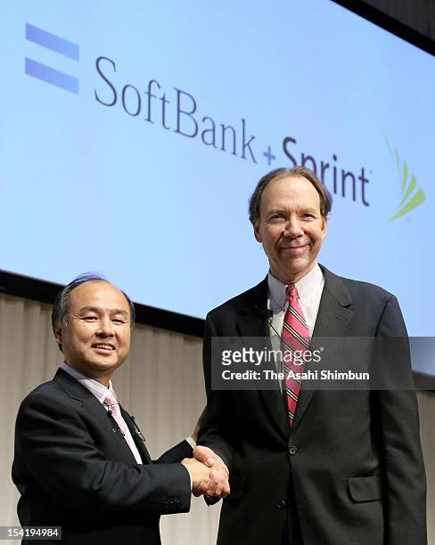Softbank Corp., chairman and CEO Masayoshi Son and Sprint Nextel Corp., President and CEO Dan Hesse shake hands during a press conference on October...