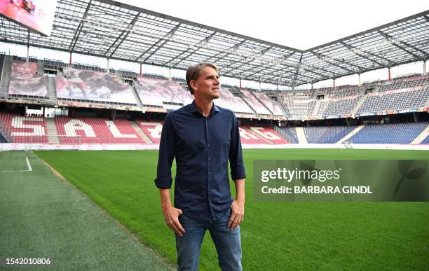 Red Bull Salzburg's outgoing sporting director Christoph Freund walks on the pitch ahead of a press conference on July 19 with Freund moving to...