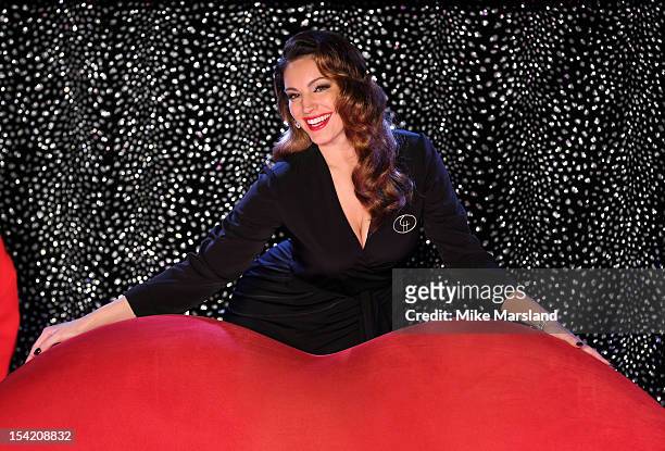 Kelly Brook poses at a photocall as she joins the cast of Crazy Horse at The National Theatre on October 16, 2012 in London, England.