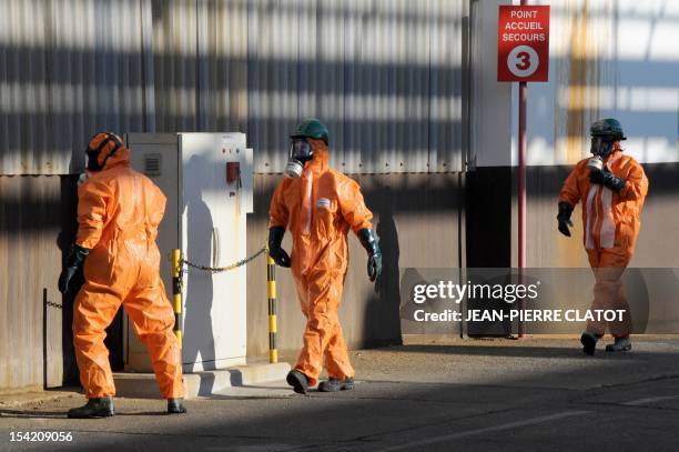 Employees wearing protection suits are seen during a security exercice in Jarrie, southeastern France inside the Jarrie site of CEZUS, an AREVA group...