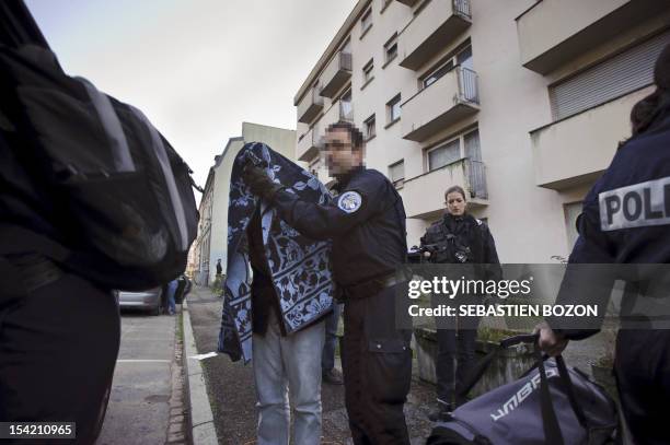 Man is arrested by the police during an operation to dismantle a drug trafficking and clandestine immigration network in Mulhouse, eastern France, on...