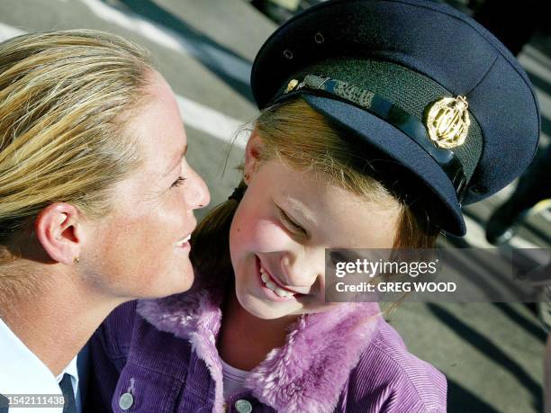 Corporal Melinda Cotton from the Royal Australian Air Force jokes with daughter Shannon in Sydney, 18 June 2003. Cotton had just joined 1,500 of the...