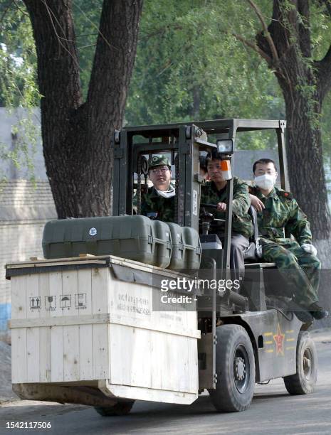 Chinese People's Liberation Army medical staff uses a forklift to deliver medical equipment to the hospital erected in barely a week to house a...