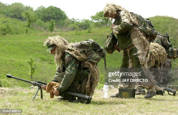 Marine snipers with their 50 caliber Special Application Scope Rifle man their position during the "Balikatan" joint US-Philippines military...