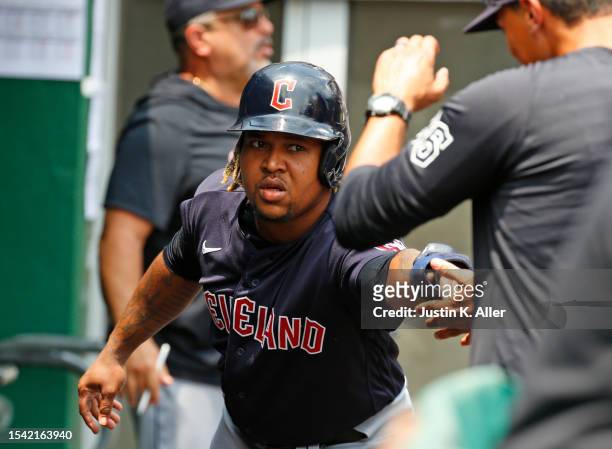 Jose Ramirez of the Cleveland Guardians celebrates after scoring on a bunt single in the fourth inning against the Pittsburgh Pirates during...