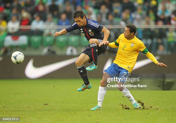 Adriano Claro of Brazil battles for the ball with Yuto Nagatomo of Japan during the men's international friendly match between Brazil and Japan at...