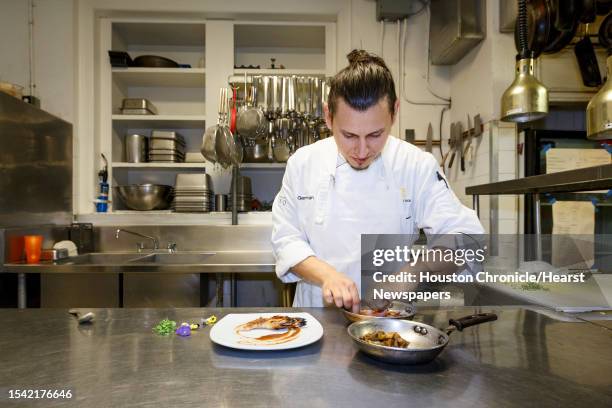 Chef German Mosquera plates the Grilled Prawns with Smoked Eggplant, Roast Hazelnuts and Membrillo at Restaurant CINQ inside La Colombe d'Or Hotel,...