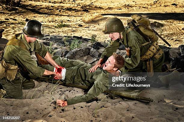 wwii soldiers - medic wounded and private triage - injured us army stock pictures, royalty-free photos & images