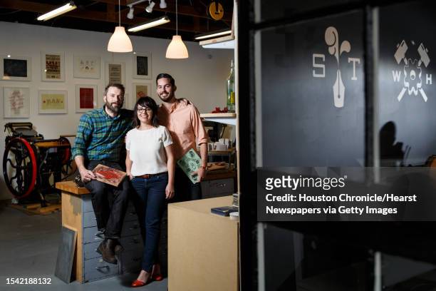 John Earles, left to right, Jennifer Blanco and Joe Ross pose for a photo in their graphic design and printing business Spindletop Design and...
