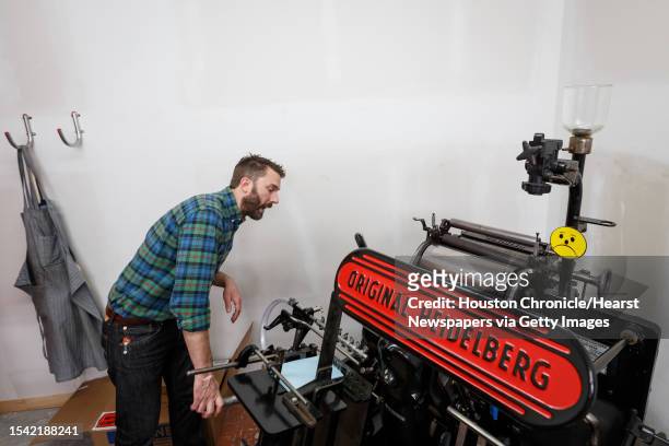 John Earles works on a Heidelberg Windmill printing press at Spindletop Design and Workhorse Printmakers, Wednesday, Aug. 28 in Houston. Jennifer...
