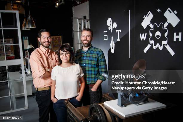 Joe Ross, left to right, Jennifer Blanco and John Earles pose for a photo at the front of their graphic design and printing business Spindletop...