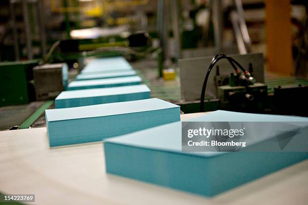 Reams of blue paper travel toward a wrapping machine at the Domtar Paper Co. Paper mill in Rothschild, Wisconsin, U.S., on Wednesday, Oct. 10, 2012....