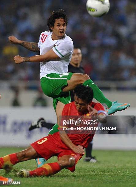 Indonesia's Irfan Haarys Bachdim kicks the ball next to Vietnam's Nguyen Minh Duc during a friendly match at Hanoi's My Dinh stadium on October 16,...