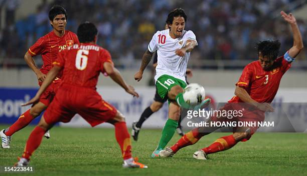 Indonesia's Irfan Haarys Bachdim kicks the ball among Vietnamese players during a friendly match at Hanoi's My Dinh stadium on October 16, 2012. The...