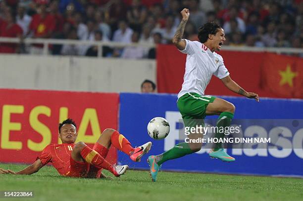Vietnam's Nguyen Trong Hoang vies for the ball with Indonesia's Irfan Haarys Bachdim during a friendly match at Hanoi's My Dinh stadium on October...