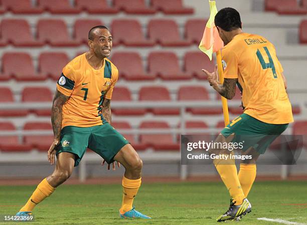 Archie Thompson of Australia celebrates a goal with Tim Cahill during the 2014 FIFA World Cup Qualifier match between Iraq and Australia at Al Arabi...