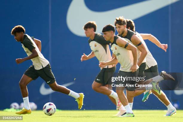 Lamine Yamal and Pedro Gonzalez 'Pedri' of FC Barcelona runs during a training session at Ciutat Esportiva Joan Gamper on July 14, 2023 in Sant Joan...