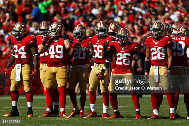 Running back Anthony Dixon of the San Francisco 49ers, Bruce Miller, Perrish Cox, Tavares Gooden, Tramaine Brock, and Darcel McBath line up for a...