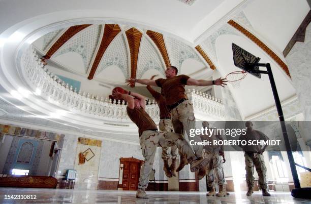 Army soldiers from the 4th Infantry Division, Task Force Ironhorse, play hoops inside one of Saddam Hussein's former palaces in Tikrit 13 November...