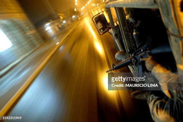 Army soldier from the US 1-22 Battalion of the 4th Infantry Division takes position inside a Humvee military vehicle during a night patrol in...