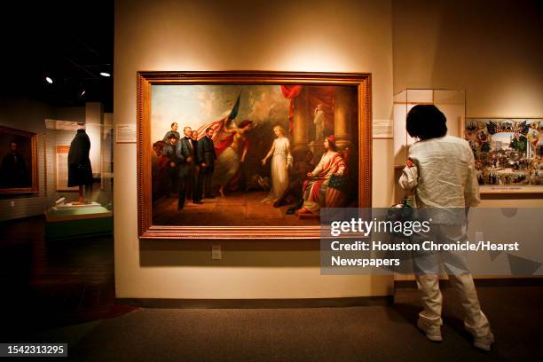 Member of the St. Elizabeth Ann Seton Catholic Church, looks at an 1865 oil painting by Dennis Malone Carter entitled "Allegory of Peace and Freedom"...