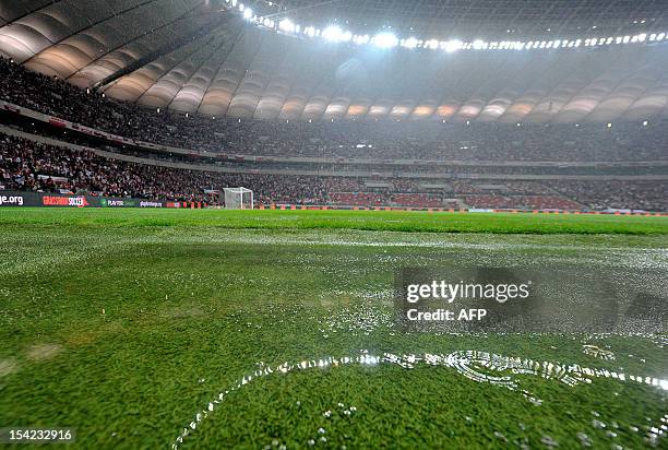 Water covers the grass at the stadium as the FIFA 2014 World Cup qualifying football match Poland vs England was delayed due to heavy rains in Warsaw...