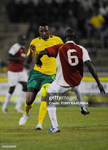 South Africa's Siyabonga Sangweni vies for the ball against Kenya's Wesley Kemboi during an international friendly football match between Kenya and...