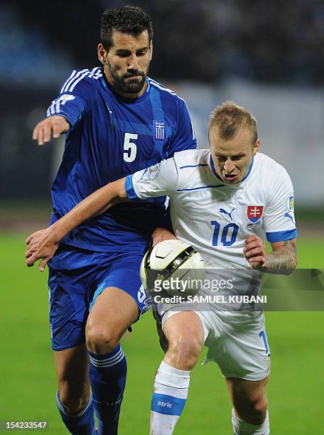 Slovakia's Marek Sapara vies for the ball with Greek Dimitrios Siovas during the FIFA 2014 World Cup qualifying football match Slovakia vs Greece in...