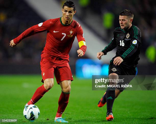 Portugal's forward Cristiano Ronaldo vies with Northern Ireland's midfielder Oliver Norwood during the FIFA World Cup 2014 qualifying football match...