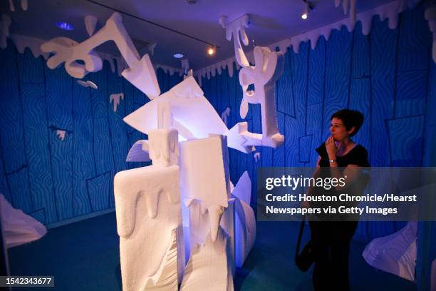 Elizabeth Marks interacts with a Wayne White sculpture at the Rice Gallery at Rice University Wednesday, Sept. 16 in Houston. The installation...