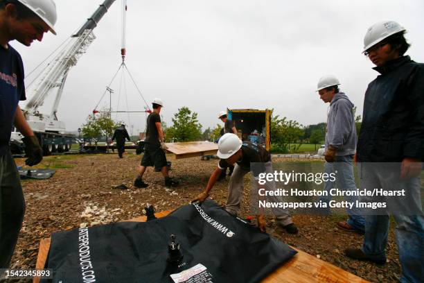 Rice University students help clean up the construction sight where a 20-ton house named "ZEROW HOUSE" was built over the last two years, and lifted...