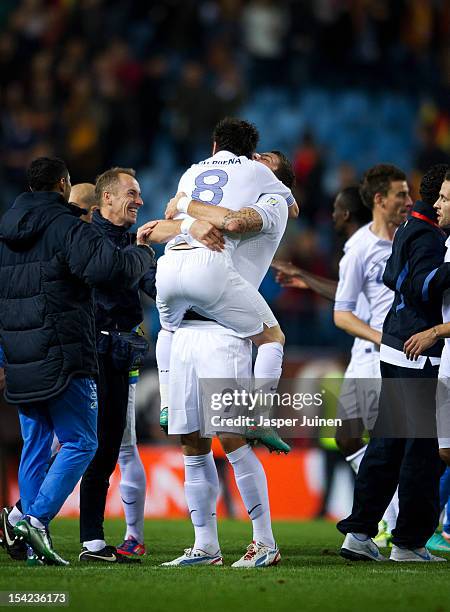 Olivier Giroud of France celebrates with Mathieu Valbuena and other teammates at the end of the FIFA 2014 Group I World Cup Qualifier game between...